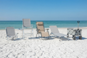 Standard beach chair, high seat chair, zero gravity chair, lounger, and beach wagon lined up on the sand